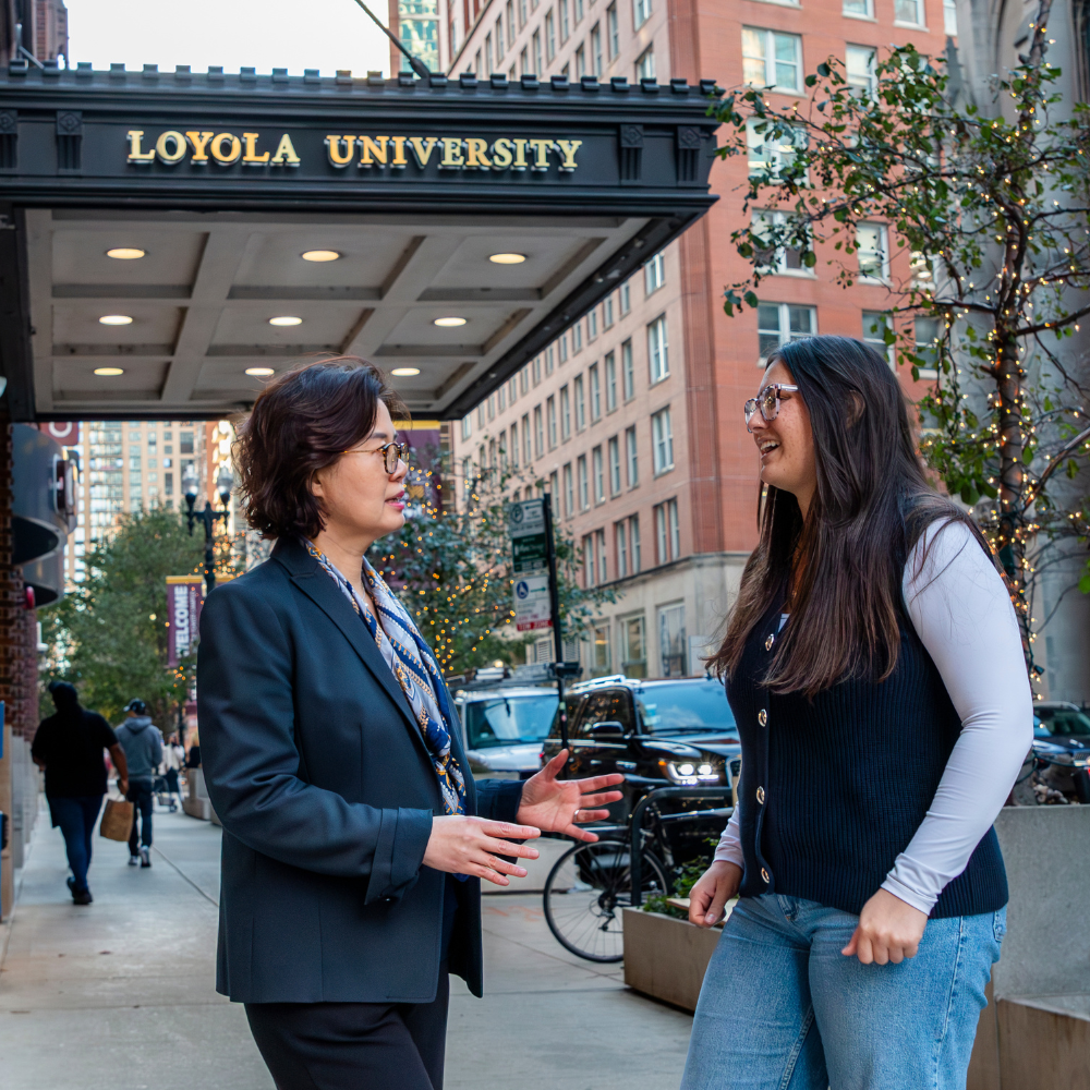 Loyola Chicago student Avery Robbins and Professor Chris Yim talking downtown